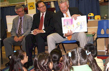 Jim Glasgow (right) reads to St. John's preschoolers in Joliet with State Sen. A.J. Wilhelmi (center) and Channahon Police Chief Joe Pena (left).